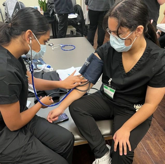 {{ school.name }} students training to take blood pressure counts {{ school.name }} students training to take blood pressure counts