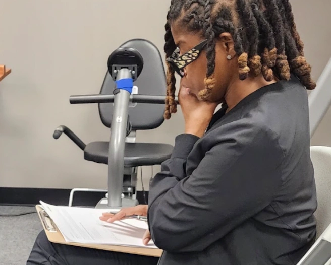 {{ school.name }} student reviewing paper work for a patient {{ school.name }} student reviewing paper work for a patient