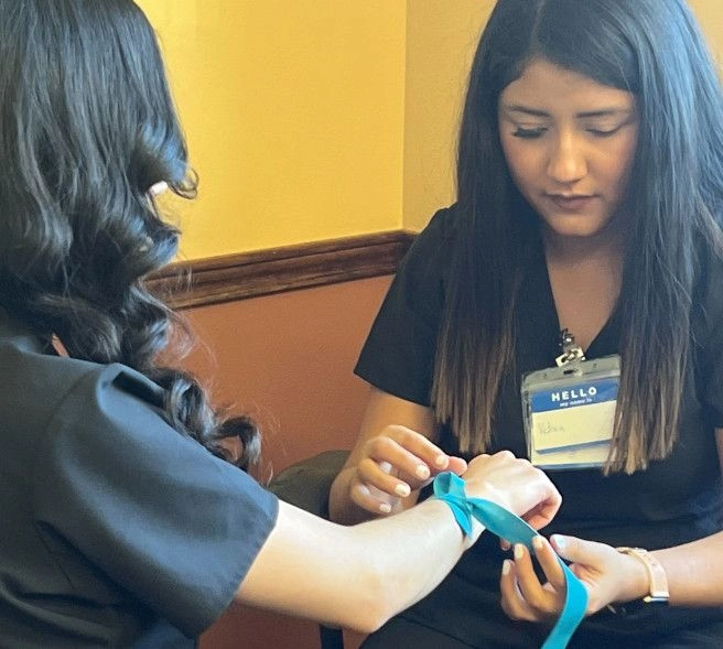 {{ school.name }} student applying a tourniquet  {{ school.name }} student applying a tourniquet