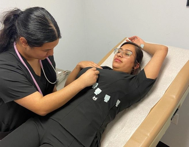 {{ school.name }} students training patient procedures {{ school.name }} students training patient procedures